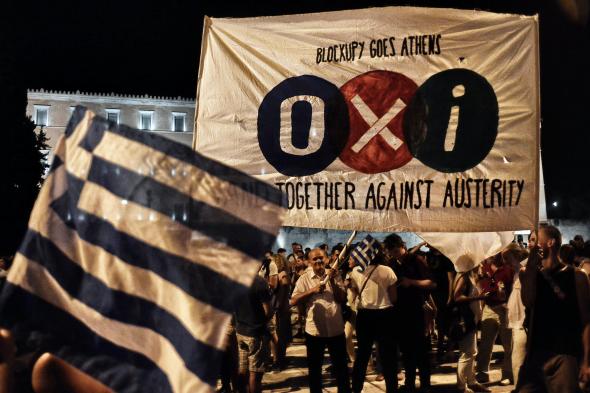 479583042-people-celebrate-in-front-of-the-greek-parliament-as_1.jpg.CROP.promovar-mediumlarge